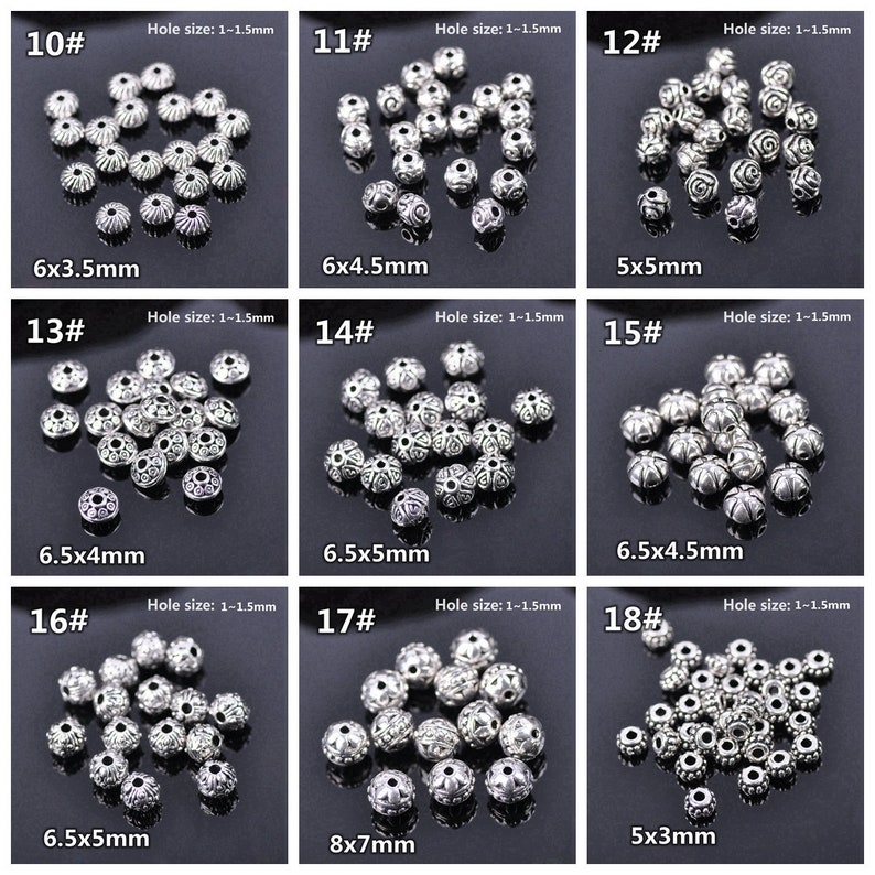 May include: Assortment of 18 silver metal beads with different sizes and designs. The beads have a hole size of 1-1.5 mm. The beads are arranged in rows of three, with each row labelled with a number from 10 to 18. The beads are all silver in colour and have a variety of designs, including floral, geometric, and abstract patterns.