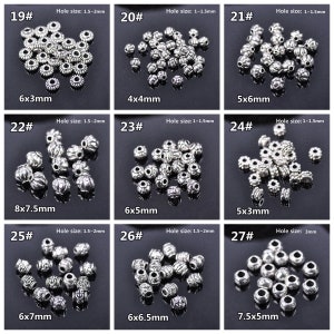 May include: Assortment of silver metal beads in various sizes and styles. The beads have a decorative design and are ideal for jewellery making. The beads are labelled with numbers and measurements in millimetres.