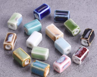 May include: Assortment of ceramic rectangular beads in various colors and patterns, including blue, green, white, brown, pink, and beige.