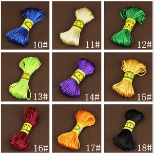 May include: Assortment of 18 colors of waxed cord, each color is wound into a coil. The cords are labeled with numbers 10 through 18.
