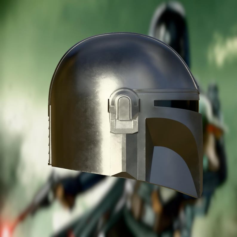 May include: A metallic silver helmet with a distinctive T-shaped visor and a rounded top. The helmet features a rectangular detail on the right side and is likely part of a costume or cosplay item.