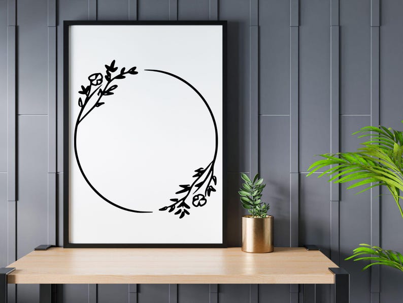 May include: Black and white floral wreath with a circular frame. The wreath is made of simple line drawings of leaves and flowers.