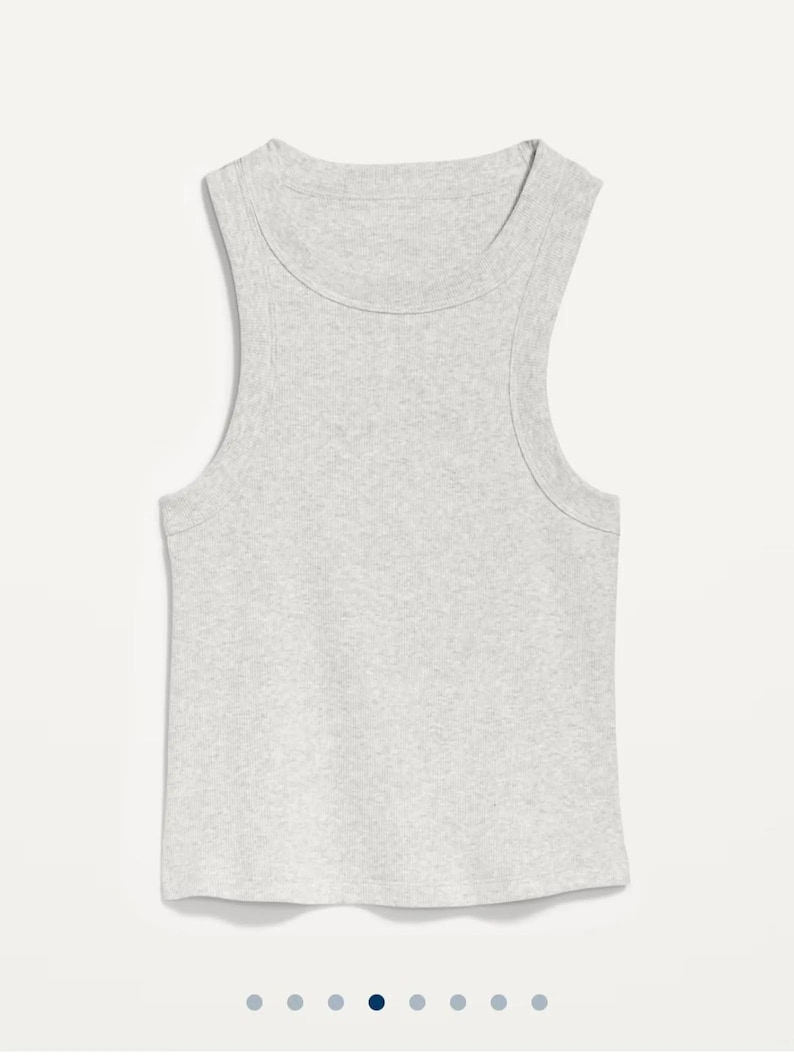 May include: A light gray ribbed tank top with a scoop neck and sleeveless design. The top is made of a soft, textured fabric and has a simple, classic style. This casual top is suitable for everyday wear.