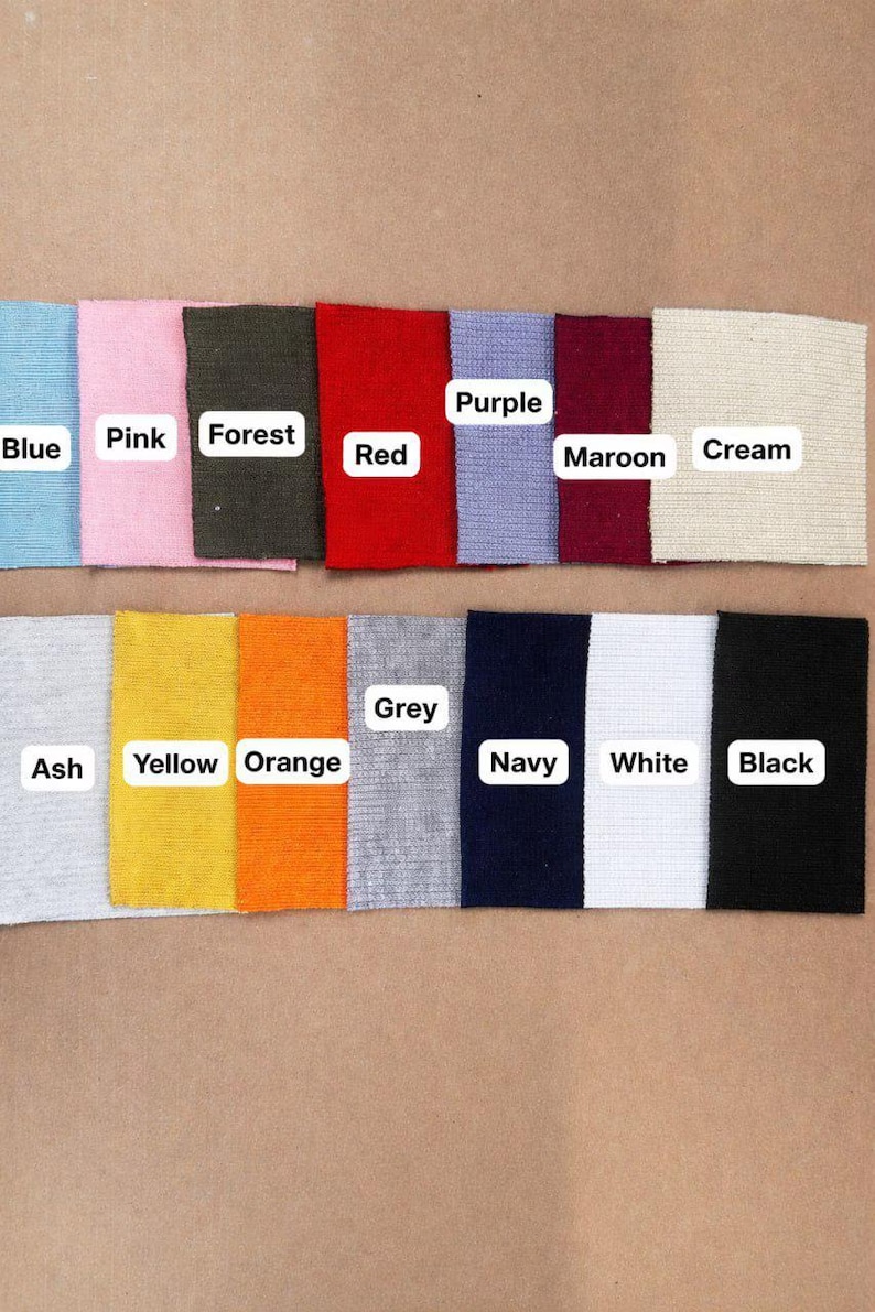 May include: A color swatch image featuring samples of fabric in various colors. Colors include blue, pink, forest green, red, purple, maroon, cream, ash, yellow, orange, grey, navy, white, and black. Each swatch has a label.