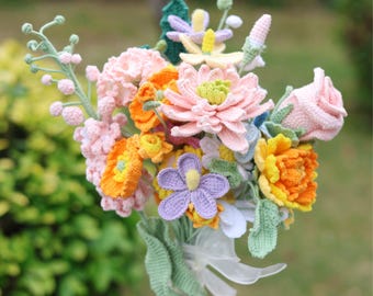 May include: A crocheted bouquet of flowers in shades of pink, yellow, orange, and purple. The bouquet includes a variety of flower types, including roses, daisies, and lilies.