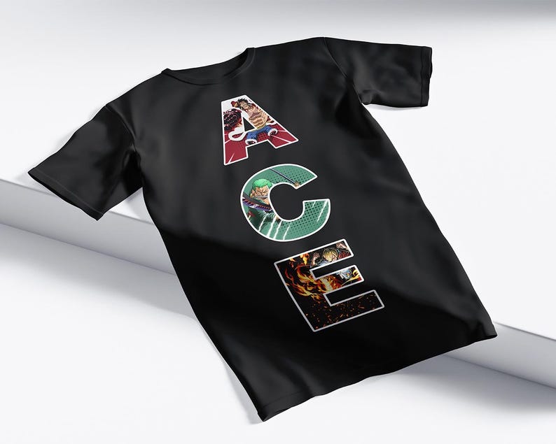 May include: Black t-shirt with the word "ACE" in white, each letter filled with a different colorful graphic. The "A" is red, the "C" is green, and the "E" is orange. The shirt is displayed on a white surface.