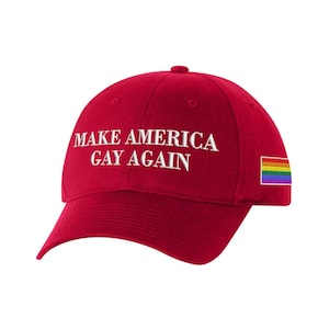 May include: Red baseball cap with the text "Make America Gay Again" in white embroidery. A rainbow pride flag is embroidered on the right side of the cap.
