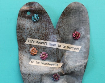 hanging rusty heart with saying 'life doesn't have to be perfect to be wonderful' on galvanized metal