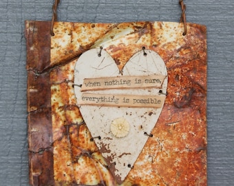 hanging wall decor - white distressed cut heart on rusty, old tin can - 'when nothing is sure, everything is possible' message