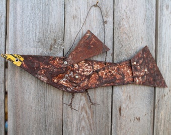 folk art bird made from rusted old, flattened, metal can and galvanized tin