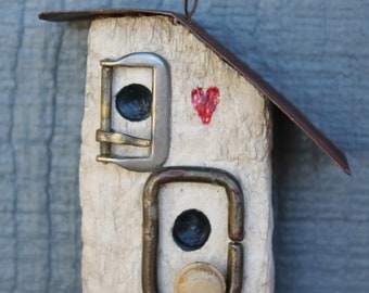 small bird house ornament made from a piece of old snow fencing - rusty metal roof