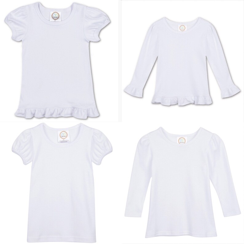 May include: Four white t-shirts with ruffled hems. Two shirts have short sleeves with puffed shoulders and two shirts have long sleeves with ruffled cuffs.