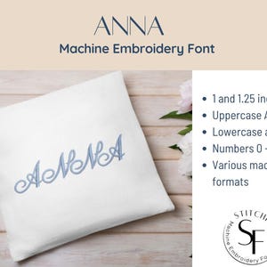 May include: A white pillow with the embroidered name "ANNA" in light blue. The image also includes text that reads "Machine Embroidery Font" and details about the font, including sizes of 1 and 1.25 inches, uppercase and lowercase letters, numbers, and various machine formats.