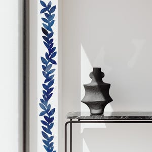 May include: A vertical wall decal featuring a repeating pattern of dark blue watercolor-style leaves arranged in a vine-like column. The design consists of individual leaf shapes in varying shades of blue, creating a continuous botanical motif.
