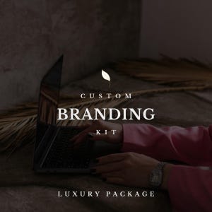 May include: A laptop with the words "CUSTOM BRANDING KIT LUXURY PACKAGE" is shown. A person's hands are typing on the keyboard. The person is wearing a pink blazer and a silver watch. The background is a dark, neutral color.