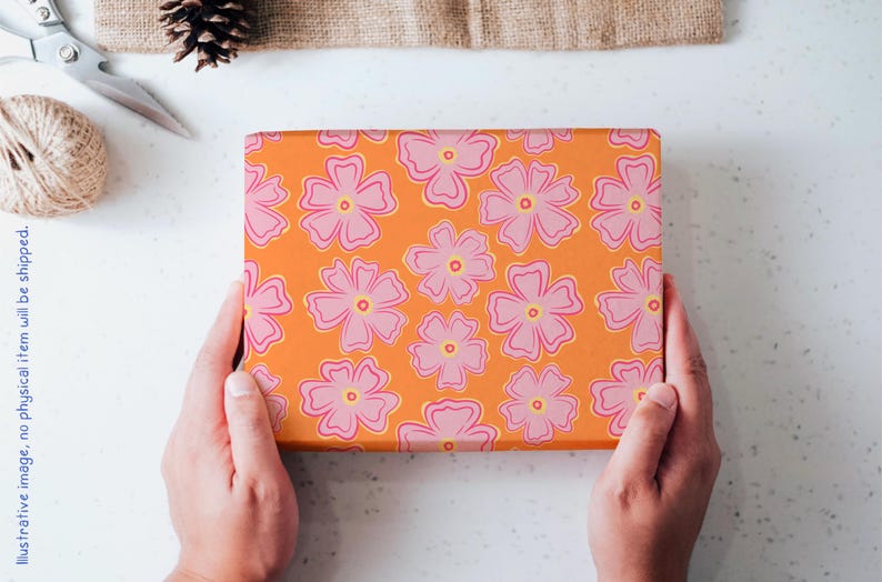 May include: A rectangular box wrapped in vibrant orange paper featuring a repeating pattern of five-petaled pink flowers with yellow centers. The floral design is evenly spaced across the surface of the box, creating a bright and colorful appearance.