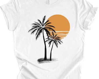 May include: White t-shirt featuring a black silhouette of two palm trees and an orange sunset.