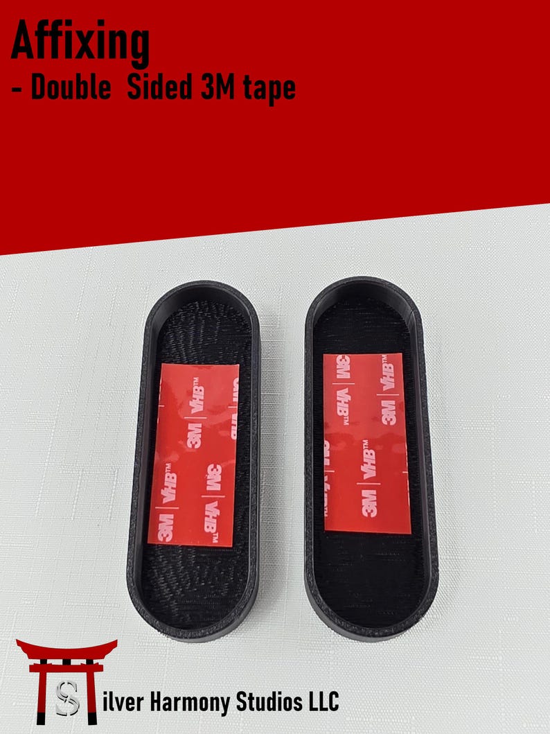 May include: Two black oval-shaped mounts with textured interiors, each featuring a rectangular red 3M VHB double-sided adhesive strip centered on the base. The text Affixing - Double Sided 3M tape is visible at the top, with Silver Harmony Studios LLC below.