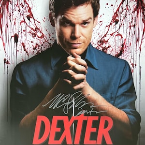 May include: A poster featuring a man in a blue shirt with the word "DEXTER" in red. The background has red splatters resembling wings. The man is holding a knife and has a signature.