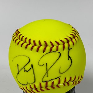 May include: Yellow softball with red stitching and a black signature that says "Ry 25".