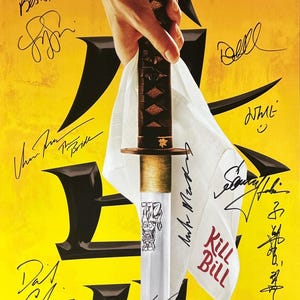 May include: A yellow poster with black kanji characters and a silver katana sword. The sword is wrapped in a white cloth with the words "Kill Bill" written in red. The poster is signed by several people, including Uma Thurman, David Carradine, and Daryl Hannah.