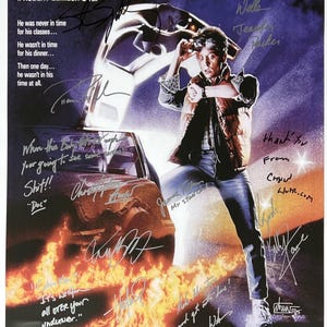 May include: A vintage movie poster for the film "Back to the Future" featuring Michael J. Fox as Marty McFly. The poster is signed by the cast and crew, including Christopher Lloyd, Lea Thompson, and Robert Zemeckis. The poster is in good condition and has some minor wear and tear.