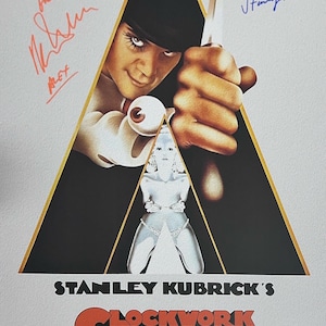 May include: A movie poster for the film "A Clockwork Orange" directed by Stanley Kubrick. The poster features a black and white image of a man in a bowler hat holding a knife, with a woman in the background. The title of the film is written in red and black letters.
