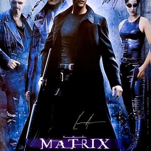 May include: The Matrix movie poster featuring Keanu Reeves, Laurence Fishburne, and Carrie-Anne Moss. The poster has the film's title in large, stylized letters, with the tagline "On March 31st The Fight For The Future Begins."