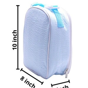 May include: A light blue insulated lunch bag with a textured surface, white trim, and a light blue handle. The bag is 10 inches tall, 8 inches wide, and 4 inches deep.