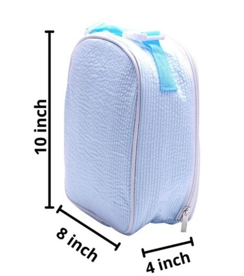 May include: A light blue insulated lunch bag with a textured surface, white trim, and a light blue handle. The bag is 10 inches tall, 8 inches wide, and 4 inches deep.