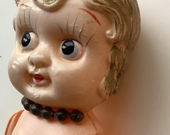 Vintage Art Deco era Cupie type celluloid doll. Black beads red shoes