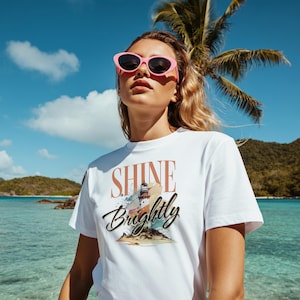 Shine Brightly Lighthouse Summer Tee, Nautical Graphic T-Shirt, Beach Vacation Apparel, Coastal Vibes Shirt, Lighthouse Lover Gift, Ocean