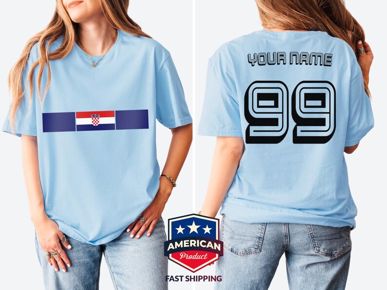 May include: A light blue t-shirt featuring the Croatian flag on the front chest. The back of the t-shirt displays the text YOUR NAME in black block letters above the large black number 99, which has a white outline and a 3D shadow effect.