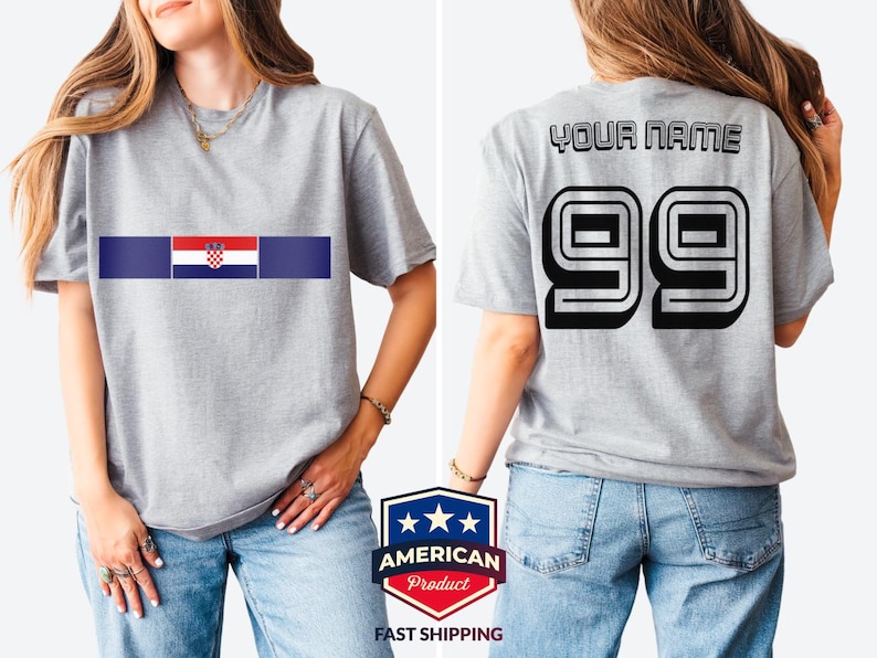 May include: A heather gray short-sleeve t-shirt featuring the Croatian flag centered on the chest. The back of the shirt displays the text YOUR NAME in black block letters above the large black outlined number 99 in a bold athletic font.
