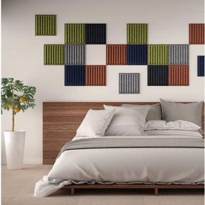 May include: A bedroom with a wooden headboard and a white bedspread. The wall behind the bed is decorated with a colorful geometric pattern of square acoustic panels in shades of green, gray, blue, and red.