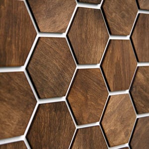 May include: A wall covered in brown hexagonal tiles with white grout lines. The tiles are arranged in a repeating pattern.