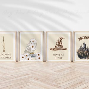 May include: Four framed art prints with a beige background. The prints feature a wand, an owl with letters, a sorting hat, and Hogwarts castle. Text on the prints reads: "MAGIC RUNS IN THE FAMILY", "BRAVE AT HEART", and "HOGWARTS".
