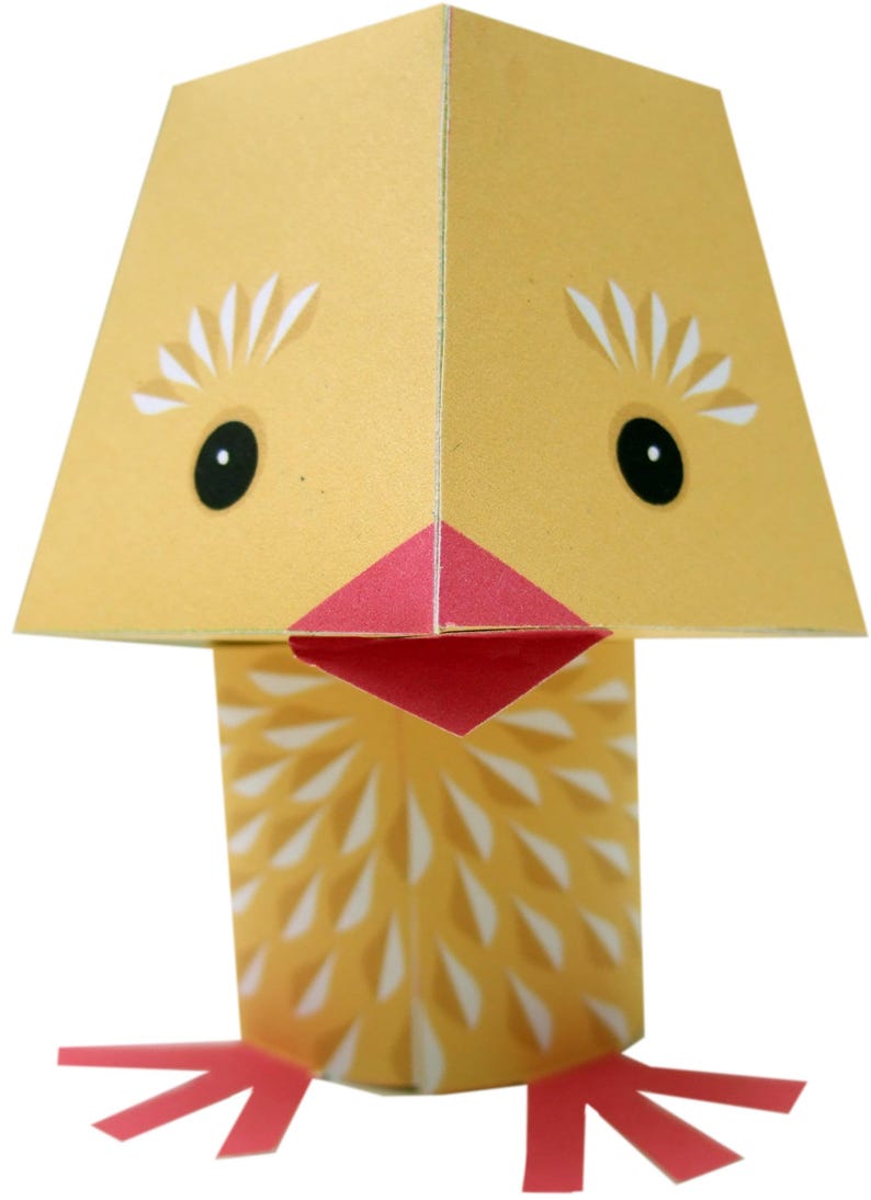 May include: A yellow paper chick with a red beak and feet. The chick has white eyes and a white pattern on its body.