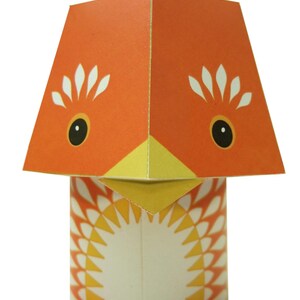 May include: A paper craft of a chick with a red crown, orange body, yellow beak, and white eyes. The chick has a white and orange patterned body and red feet.