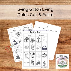 May include: Two worksheets with the text "Living & Non Living Color, Cut, & Paste" and a "Control Chart" with living and nonliving images. A pair of scissors is next to the worksheets. The worksheets are on a wooden surface.