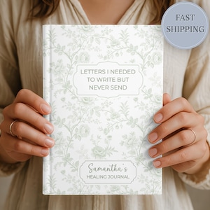 May include: A white journal with a floral pattern and the text "Letters I Needed to Write But Never Send." The journal also has the text "Samantha's Healing Journal."