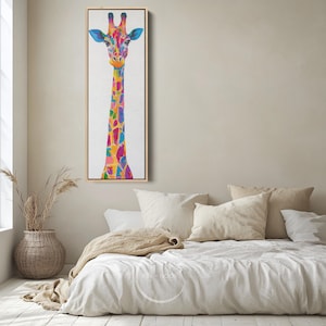 May include: A vibrant giraffe painting in a light wooden frame. The giraffe's long neck and body are adorned with colourful patches of blue, pink, yellow, and orange. The artwork is set against a white backdrop, suitable for a bedroom.