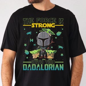 Personalized The Force Is Strong With This Dadalorian Shirt, Mandalorian Dad T-Shirt With Kids Names, Star Wars Father Day Tees Gift