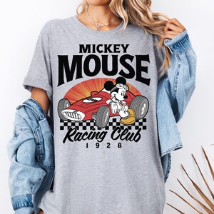 a woman wearing a mickey mouse racing club shirt