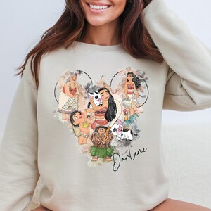 a woman wearing a sweatshirt with a picture of pooh on it
