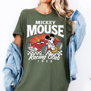 a woman wearing a mickey mouse racing club shirt