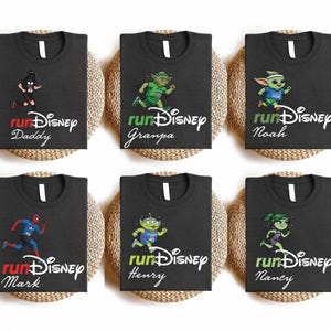 six black t-shirts with Disney characters printed on them, each with a different character and name.
