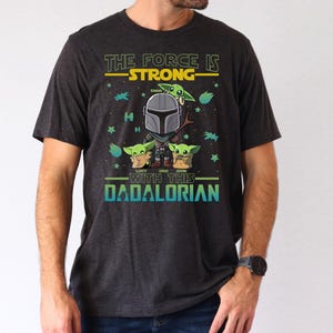 Personalized The Force Is Strong With This Dadalorian Shirt, Mandalorian Dad T-Shirt With Kids Names, Star Wars Father Day Tees Gift