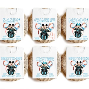 May include: Six white t-shirts featuring a blue and red Mickey Mouse design. The shirts read "Daddy of the Birthday Boy", "Charlie the 4", "Mommy of the Birthday Boy", "Brother of the Birthday Boy", "Sister of the Birthday Boy", and "Brother of the Birthday Boy".