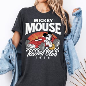 a woman wearing a mickey mouse racing club shirt